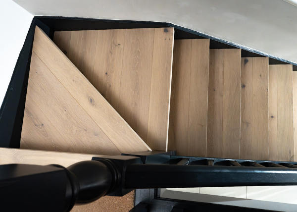 Engineered wood flooring and a white tv unit and couch